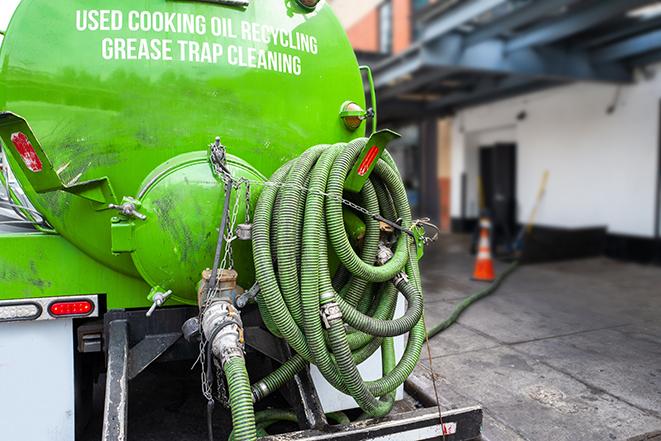 a vacuum truck pumping out a large underground grease trap in Buzzards Bay MA